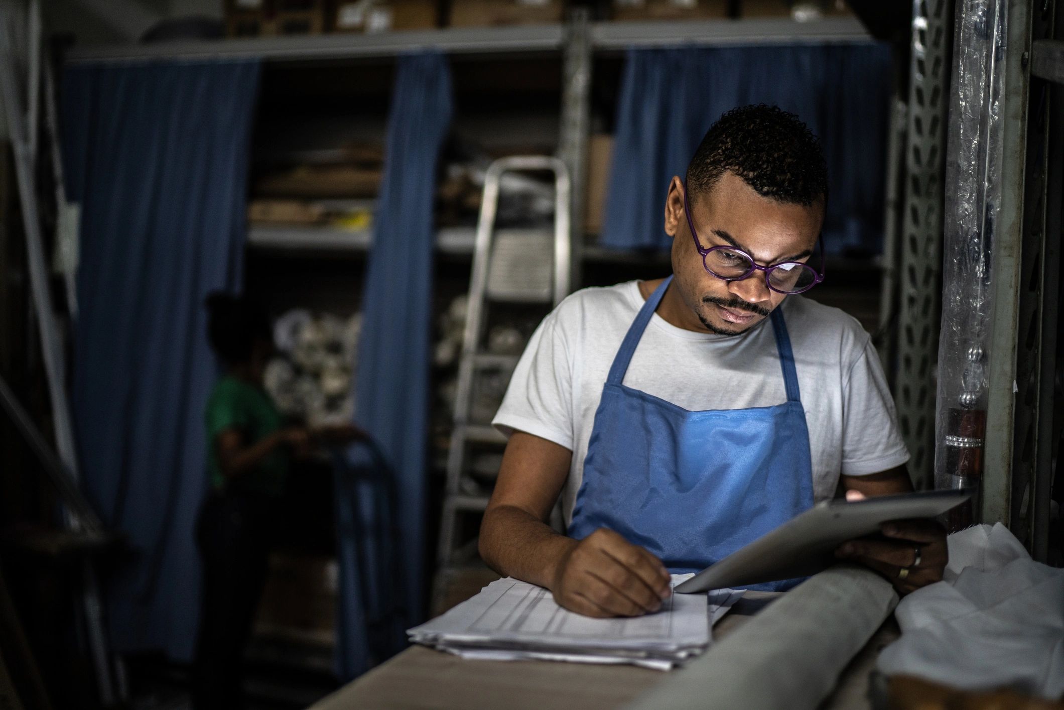 Operations manager reviewing notes in a warehouse