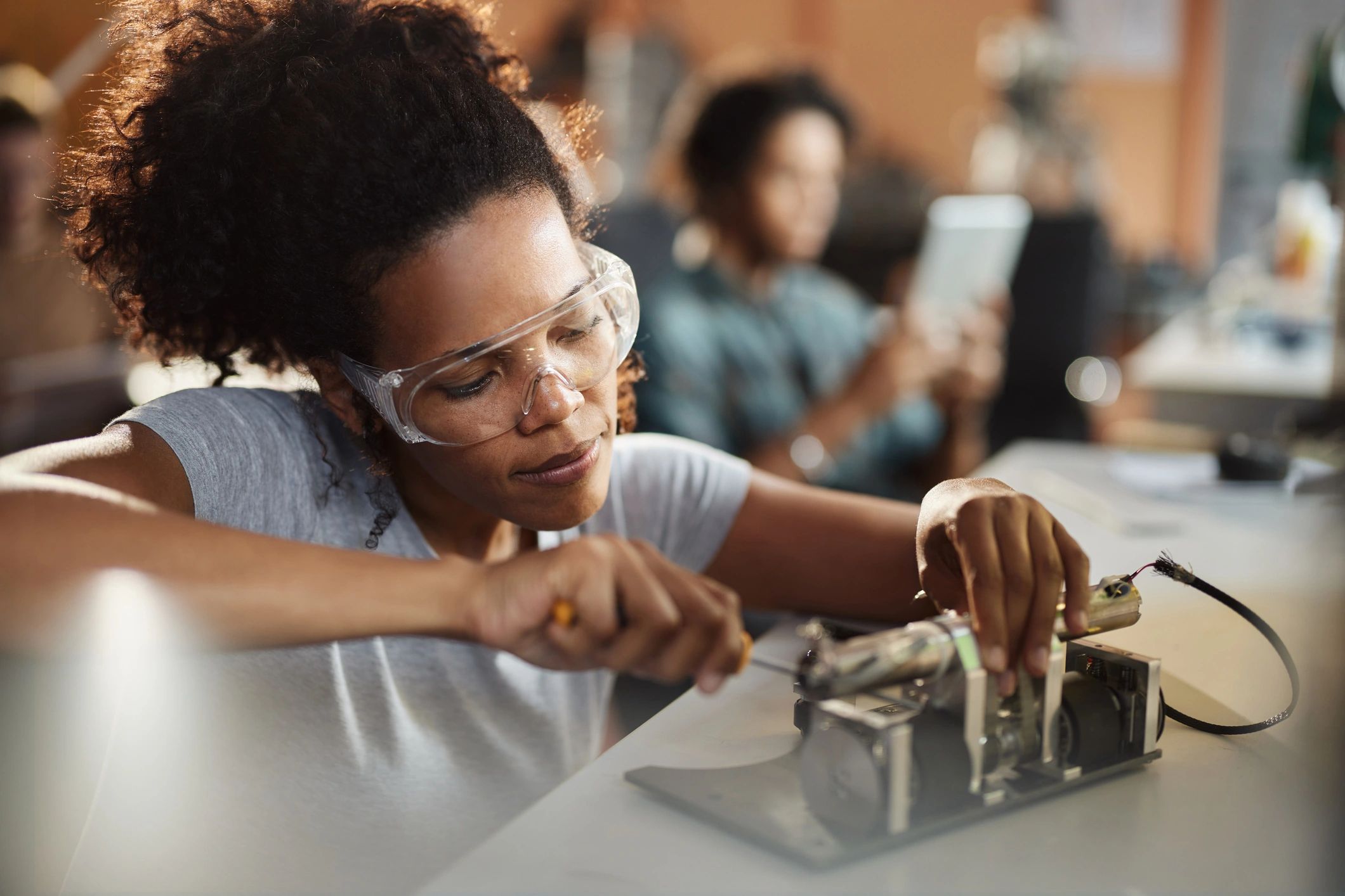 Engineer working on an electronics prototype in a lab
